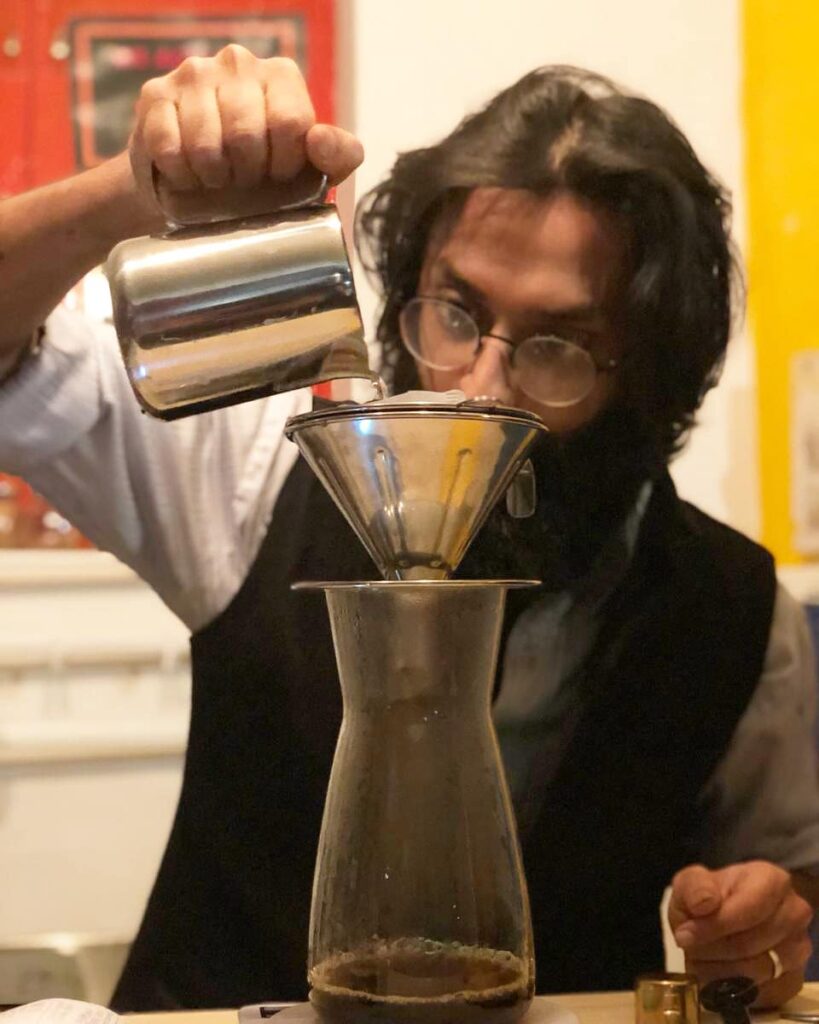 Terrassen Cafe's Dhanesh preparing a creafted cupof clear coffee